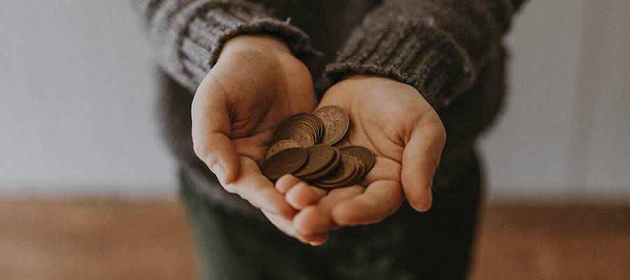 A person holding coins.