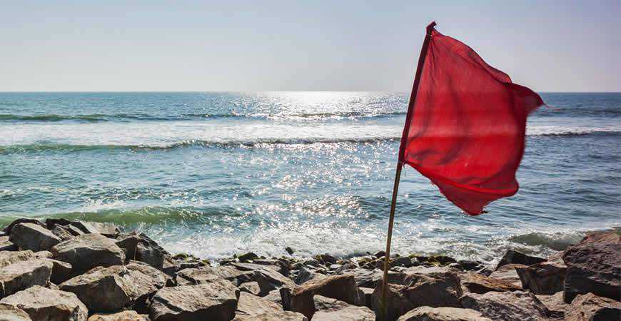 red flag stormy sea