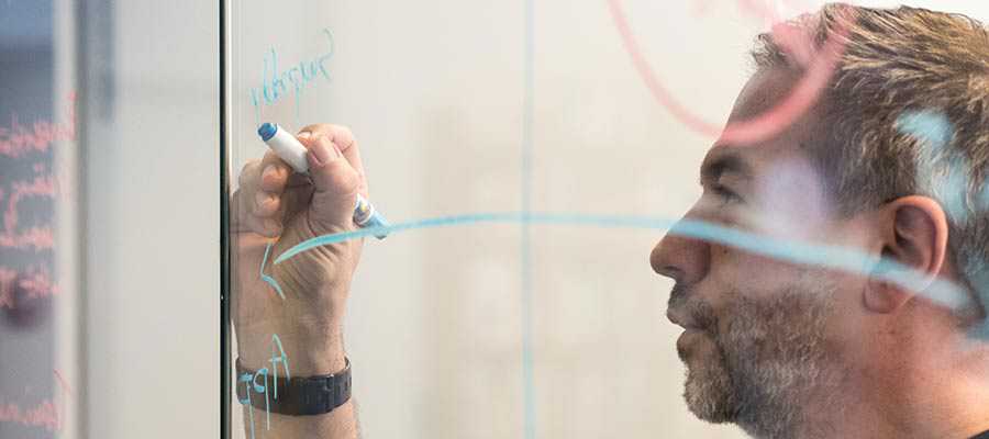 A person holds a marker.