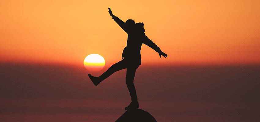 Person balancing on a stone.