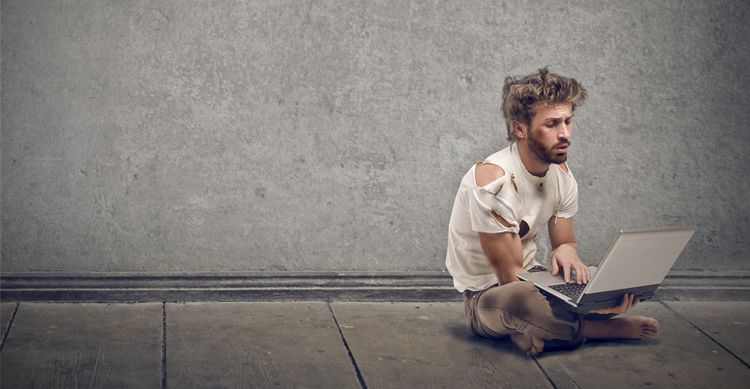 tramp sitting on the floor with laptop