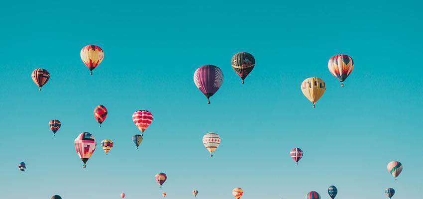 Hot air baloons in the sky.