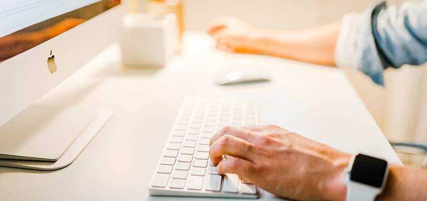 A man using a desktop computer.