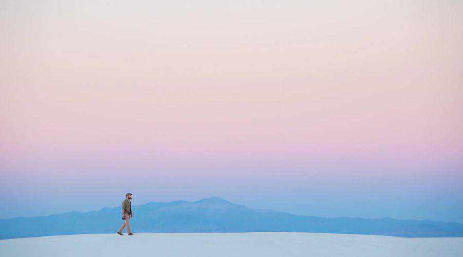 Lone Man Walking Under Pastel Sky minimal minimalistic desktop wallpaper hd 4k high-resolution