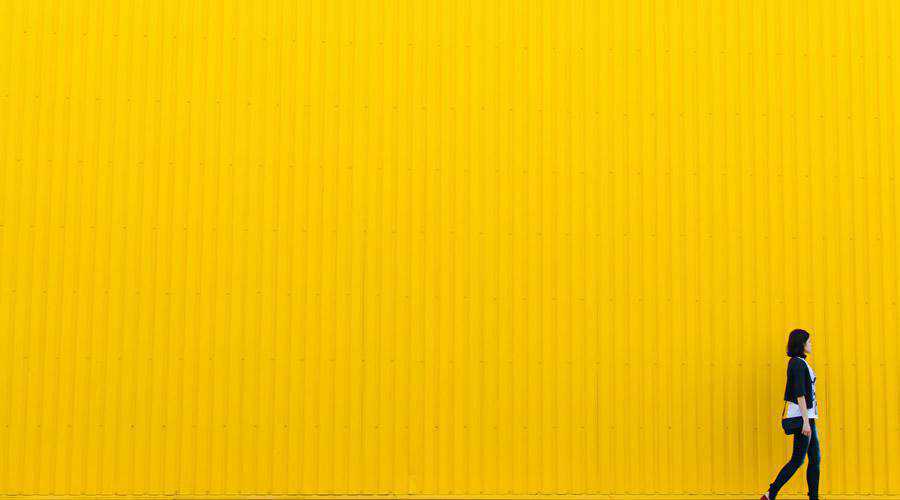 Woman Walking Past Yellow Wall minimal minimalistic desktop wallpaper hd 4k high-resolution