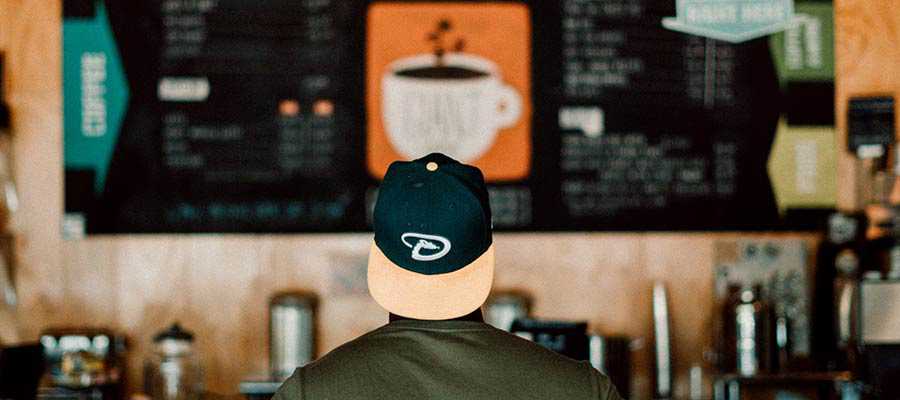 A person viewing a menu board.