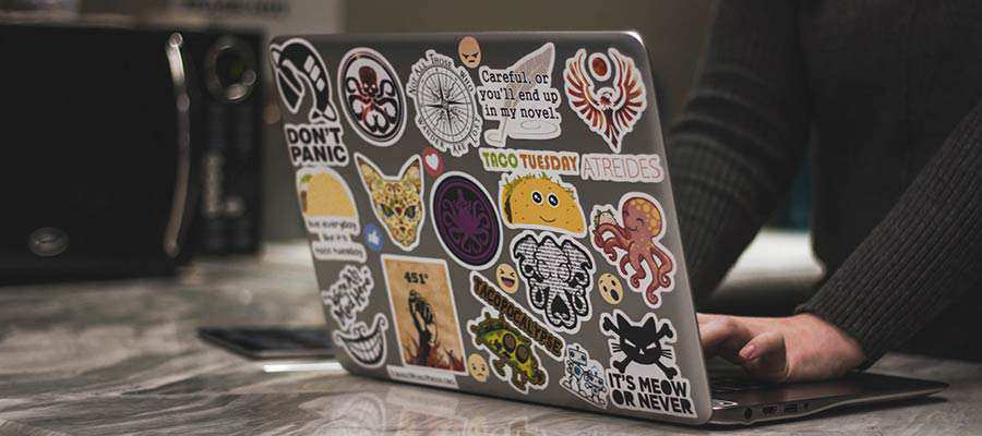 A laptop computer covered in stickers.